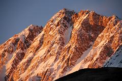 
The Shishapangma Southwest Face burns orange at sunset from Shishapangma Southwest Advanced Base Camp (5276m).
